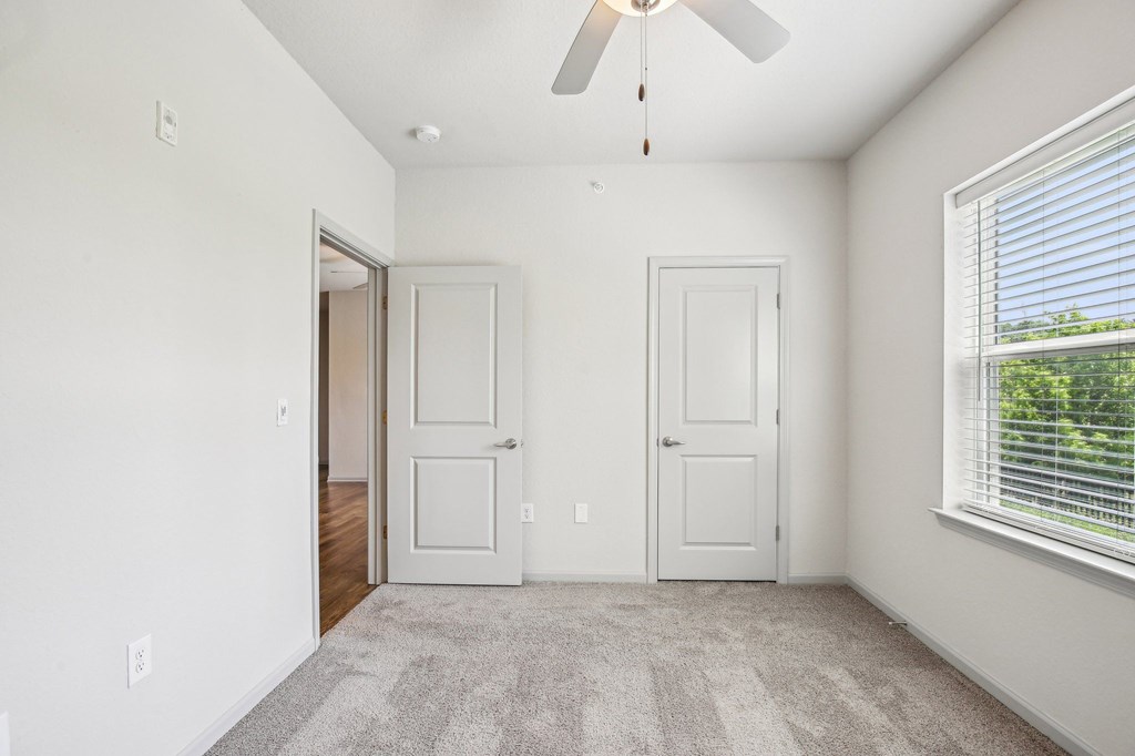 A room with a ceiling fan and two doors at Venue at 109 Apartments, Lebanon , TN, 37090