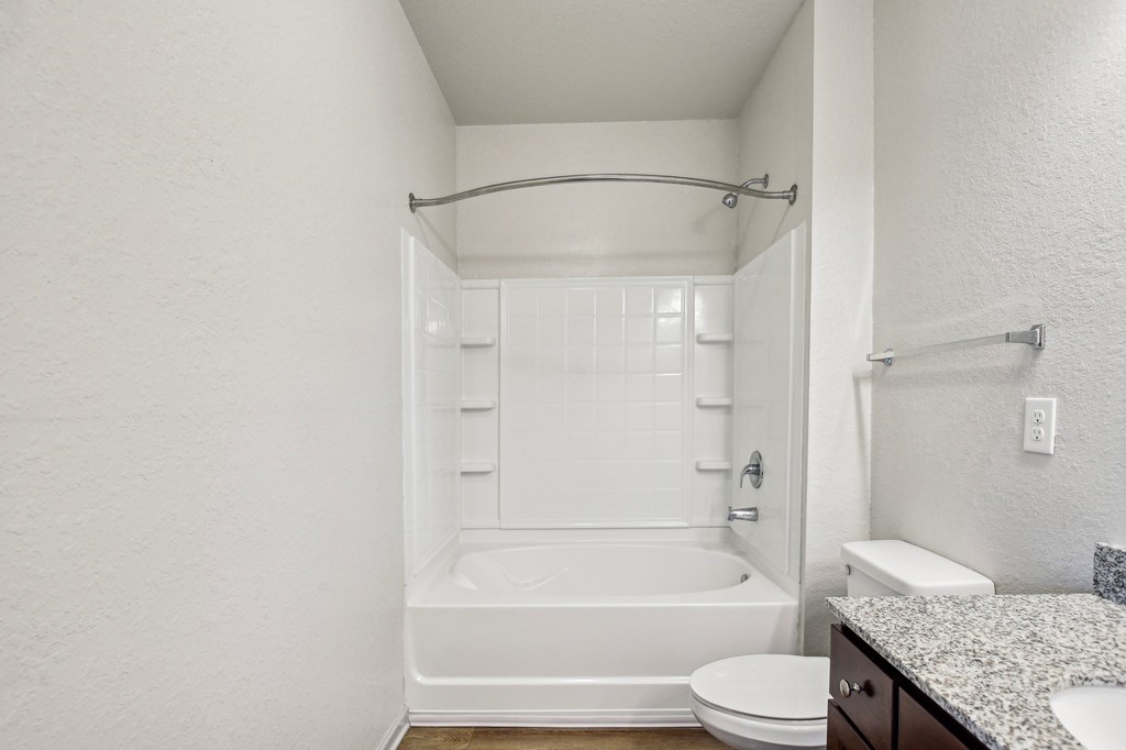 A white bathroom with a toilet, sink, and bathtub at Venue at 109 Apartments, Lebanon , Tennessee