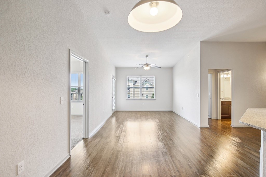 A spacious room with wooden floors and white walls at Venue at 109 Apartments, Lebanon 