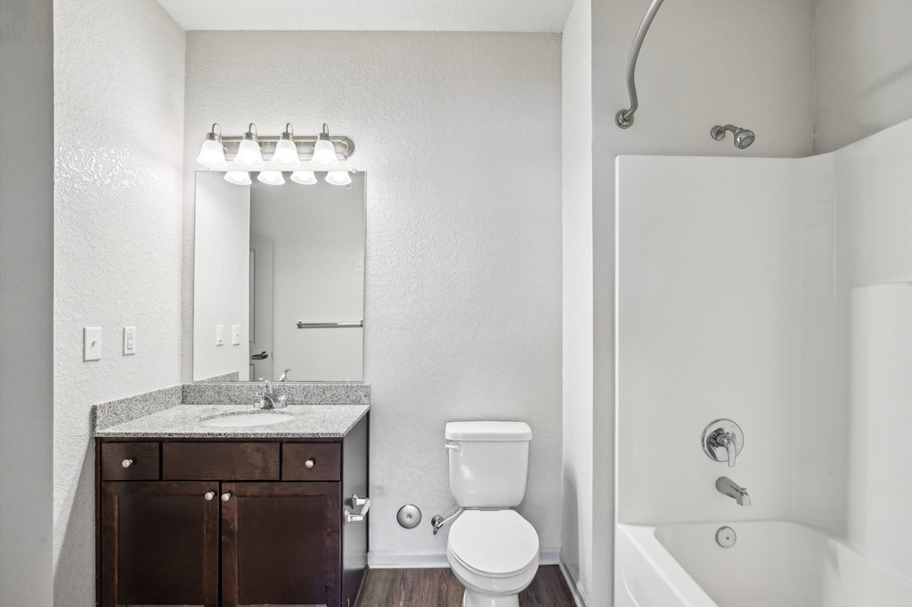 A white bathroom with a toilet, sink, and a mirror at Venue at 109 Apartments, Lebanon , TN, 37090