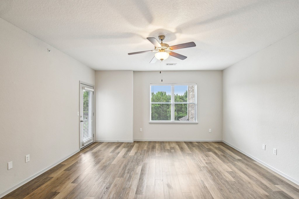 A room with a ceiling fan and a window with a view of a green landscape at Venue at 109 Apartments, Lebanon 