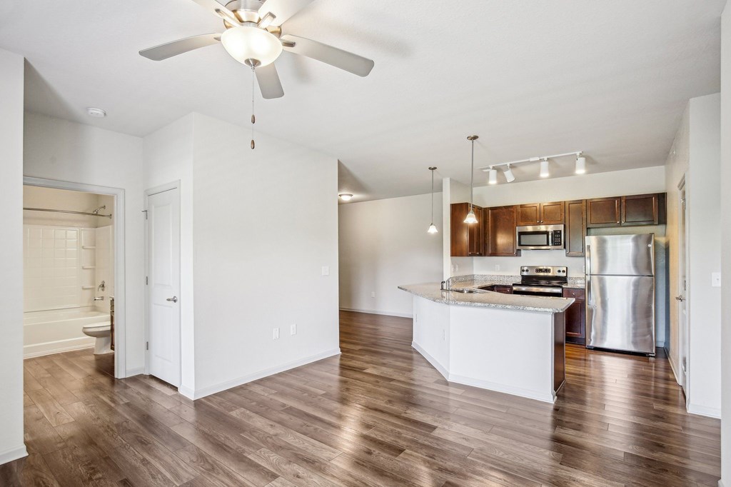 A kitchen with a white island and a ceiling fan at Venue at 109 Apartments, Tennessee