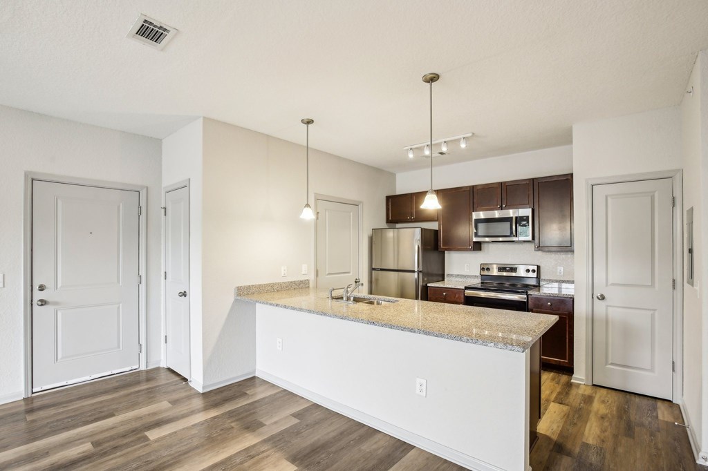 A kitchen with a granite countertop and stainless steel appliances. at Venue at 109 Apartments, Lebanon , TN