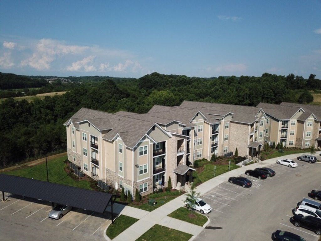 A large apartment complex with a parking lot in front. at Venue at 109 Apartments, Tennessee, 37090