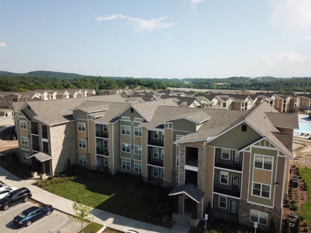 A large apartment complex with a parking lot in front. at Venue at 109 Apartments, Tennessee