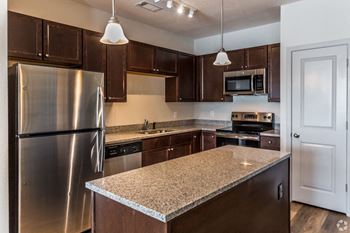 a kitchen with an island and stainless steel appliances at The Venue at 109 Apartments , Lebanon, TN, 37090