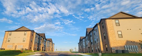 Apartment buildings with a road in front of them.