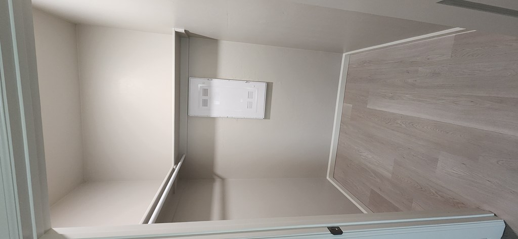 A white room with a door open to a hallway.