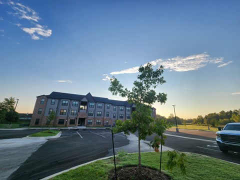 A large building with a parking lot in front of it.