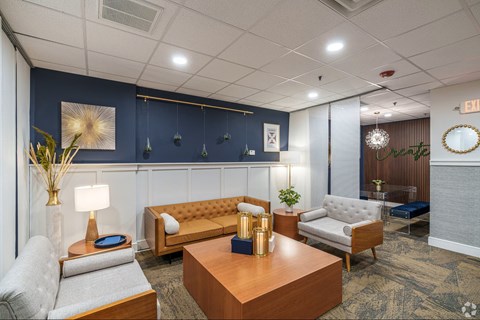 A well-lit waiting room with a variety of seating options and decorative items.