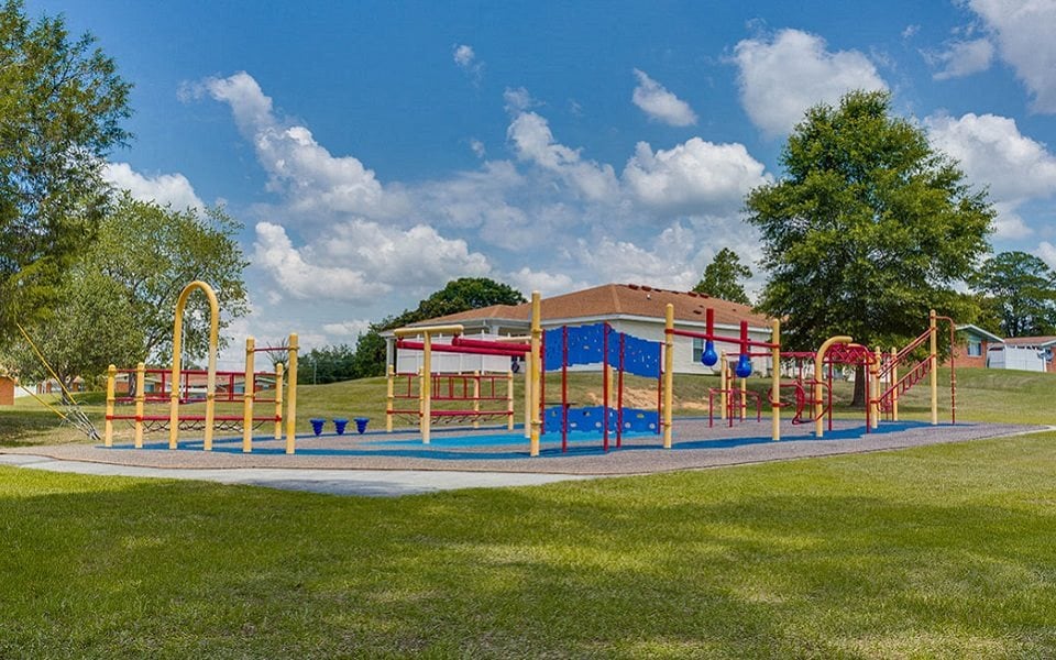 a playground on a sunny day in a park