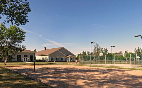 a basketball court in front of a house