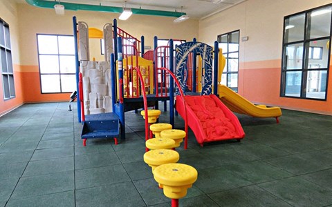 a playground with slides and other toys in a building