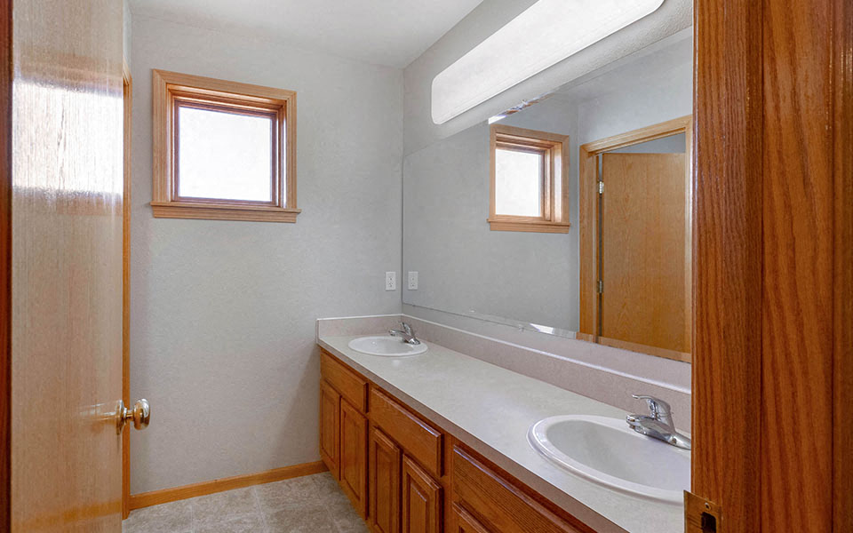 a bathroom with two sinks and a mirror