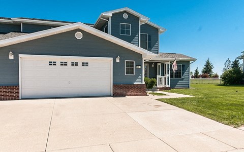 a blue house with a white garage door