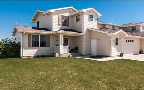 a white house with a lawn in front of it