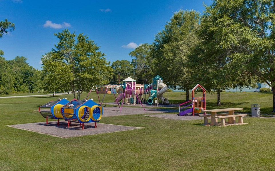 a park with a playground and a picnic table
