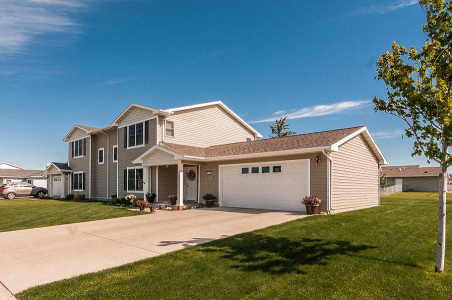 a house with a driveway and a white garage door