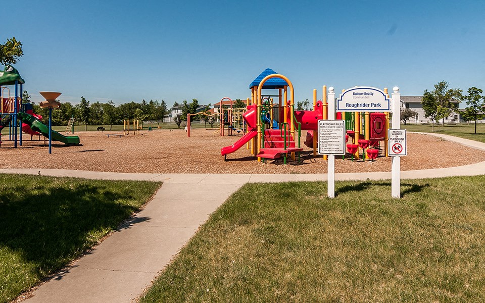 a playground with a sign in front of it