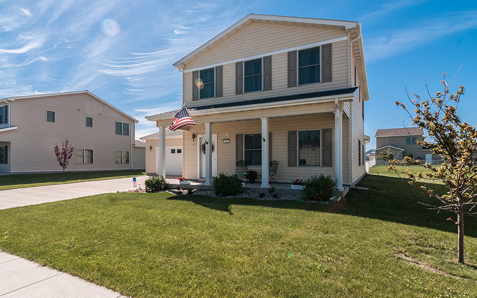 a house with an flag on the front yard