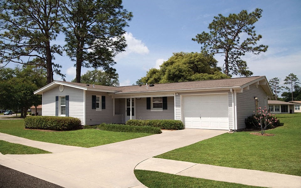 a white house with a sidewalk in front of it