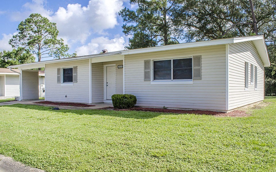 a white house with a lawn in front of it