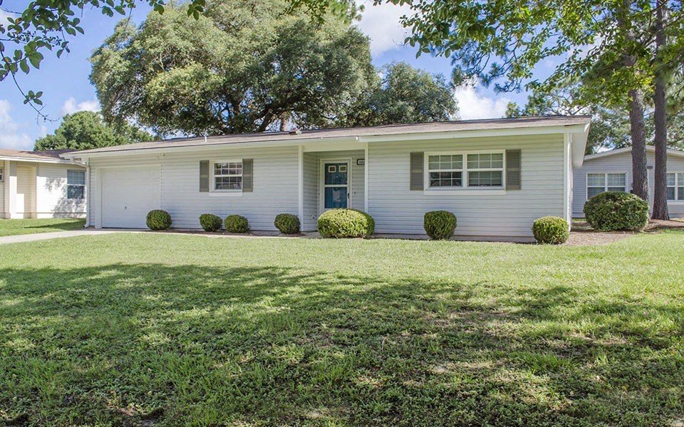 a white house with a lawn in front of it