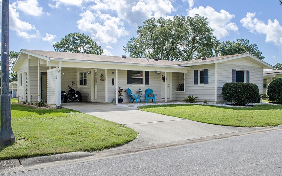 a white house with a porch and a driveway