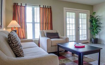a living room with couches and chairs and a coffee table