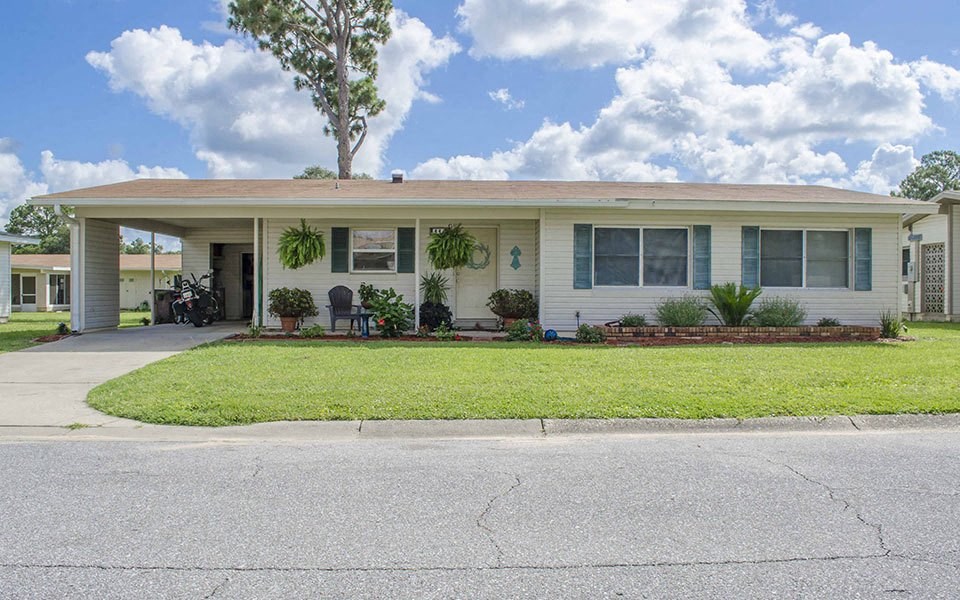 a white house with a lawn in front of it