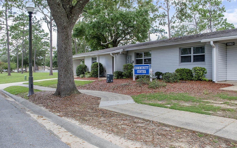 a white house with a blue for sale sign in front of it