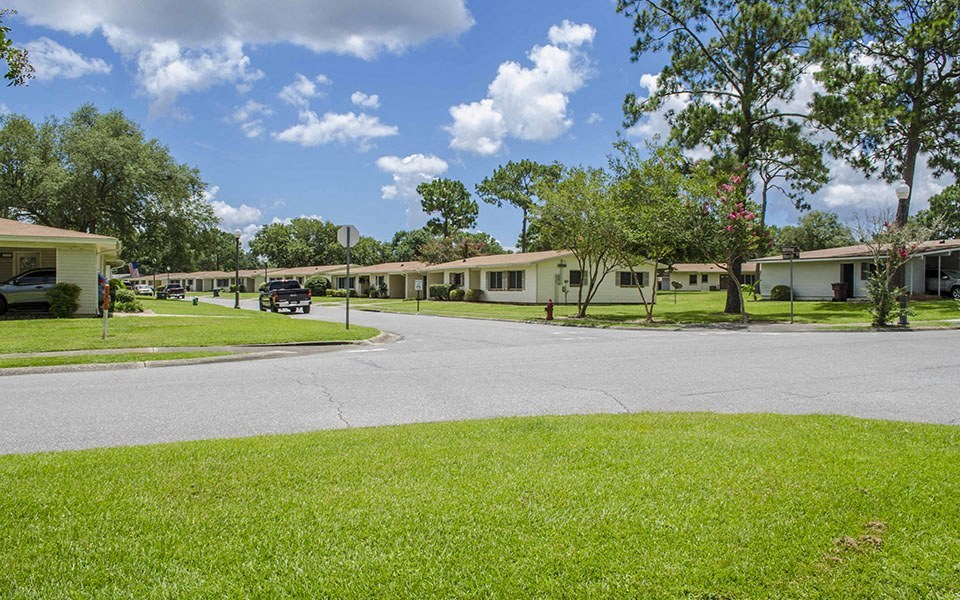 a street in a mobile home park with houses and a road