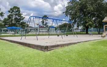 a swing set in the middle of a park