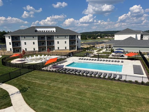 A large building with a pool in front of it.