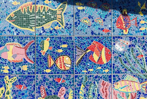 a mosaic of fish on a blue tiled wall