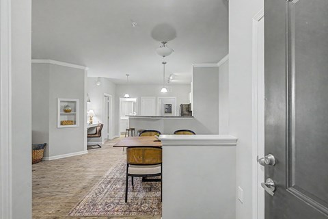A kitchen with a table and chairs in the middle of the room.