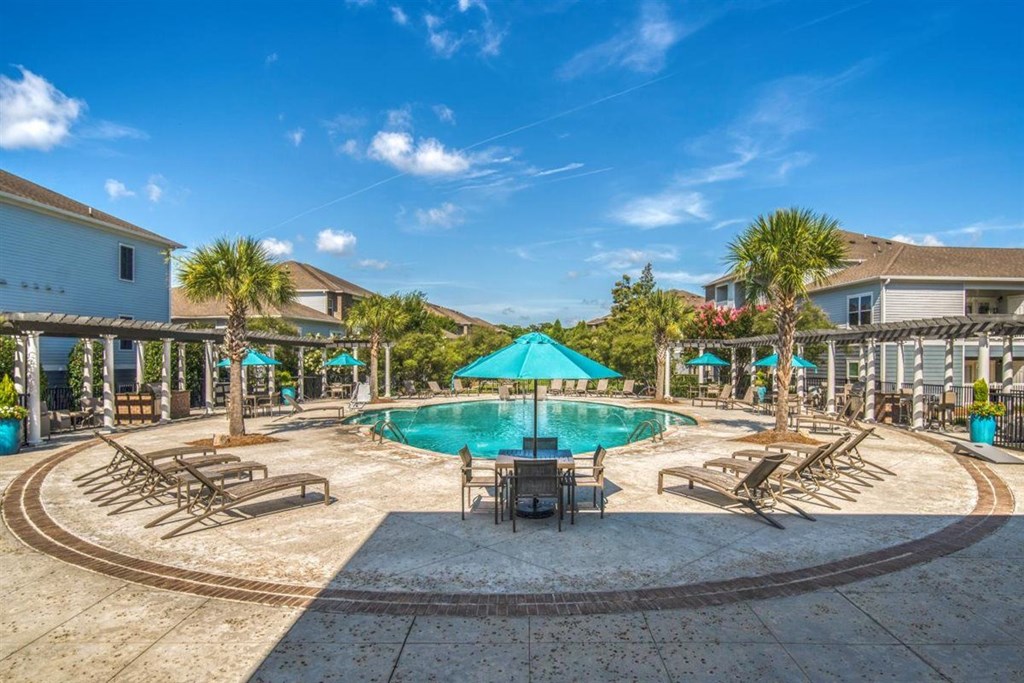 A large swimming pool surrounded by lounge chairs and umbrellas.at Cypress River, Ladson, South Carolina
