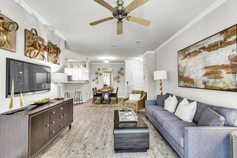 A living room with a grey couch and a wooden coffee table.