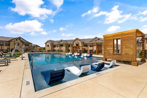 A pool with a slide and a wooden structure.