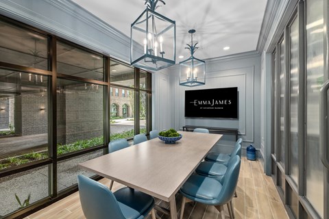 A dining room with a table and chairs and a sign that says Emma James.