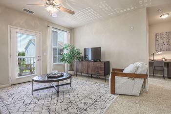 A living room with a flat screen TV and a couch.