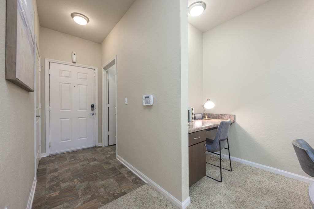 A room with a desk and a chair.