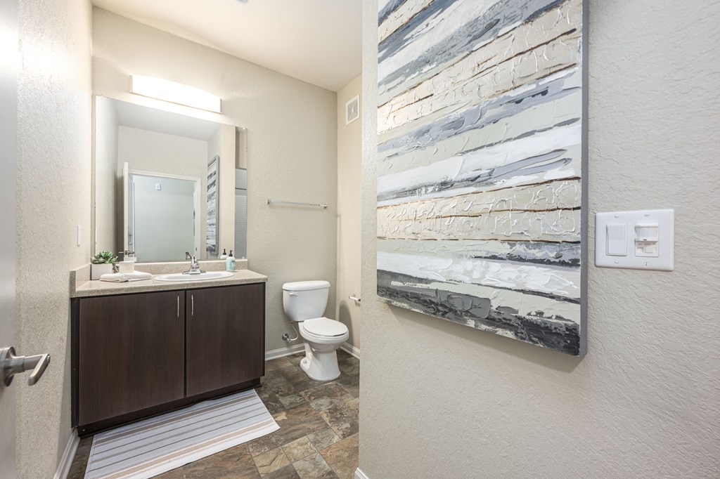 A bathroom with a marble slab on the wall.