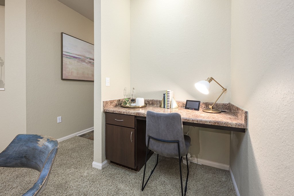 A room with a desk and chair.