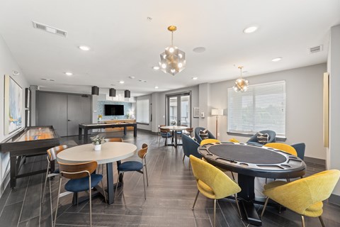 A modern dining room with a large table and chairs.