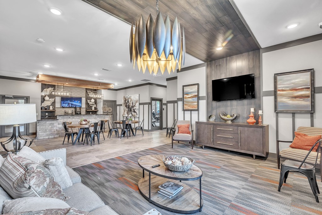 Modern living room with a grey sofa and a wooden coffee table at Sterling Creek at Richmond Hill, Richmond Hill, GA, Georgia , 31324