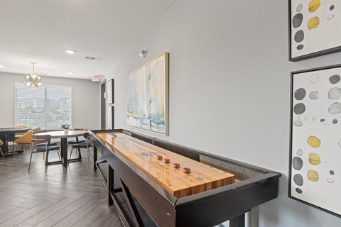 A shiny wooden pool table in a room with a painting on the wall at The Preserve at Preston Trails Apartments, Cedar Hill 75104