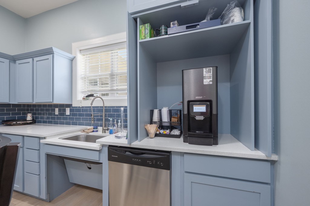A kitchen with a dishwasher and a coffee machine.at Spring Creek Apartments, Crestview Florida