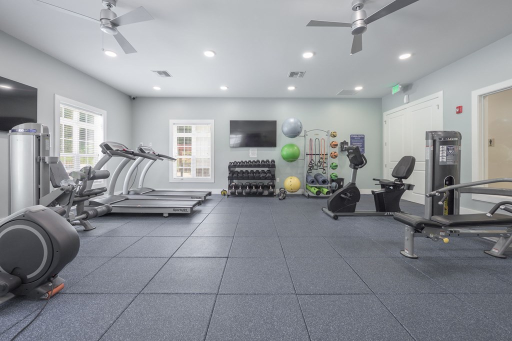 A spacious gym with treadmills, elliptical machines, and other exercise equipment.at Spring Creek Apartments, Crestview Florida