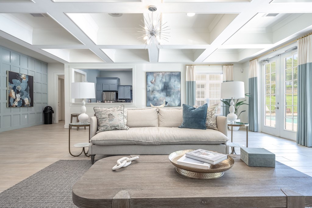 A modern living room with a large grey sofa and a wooden coffee table.at Spring Creek Apartments, Crestview
